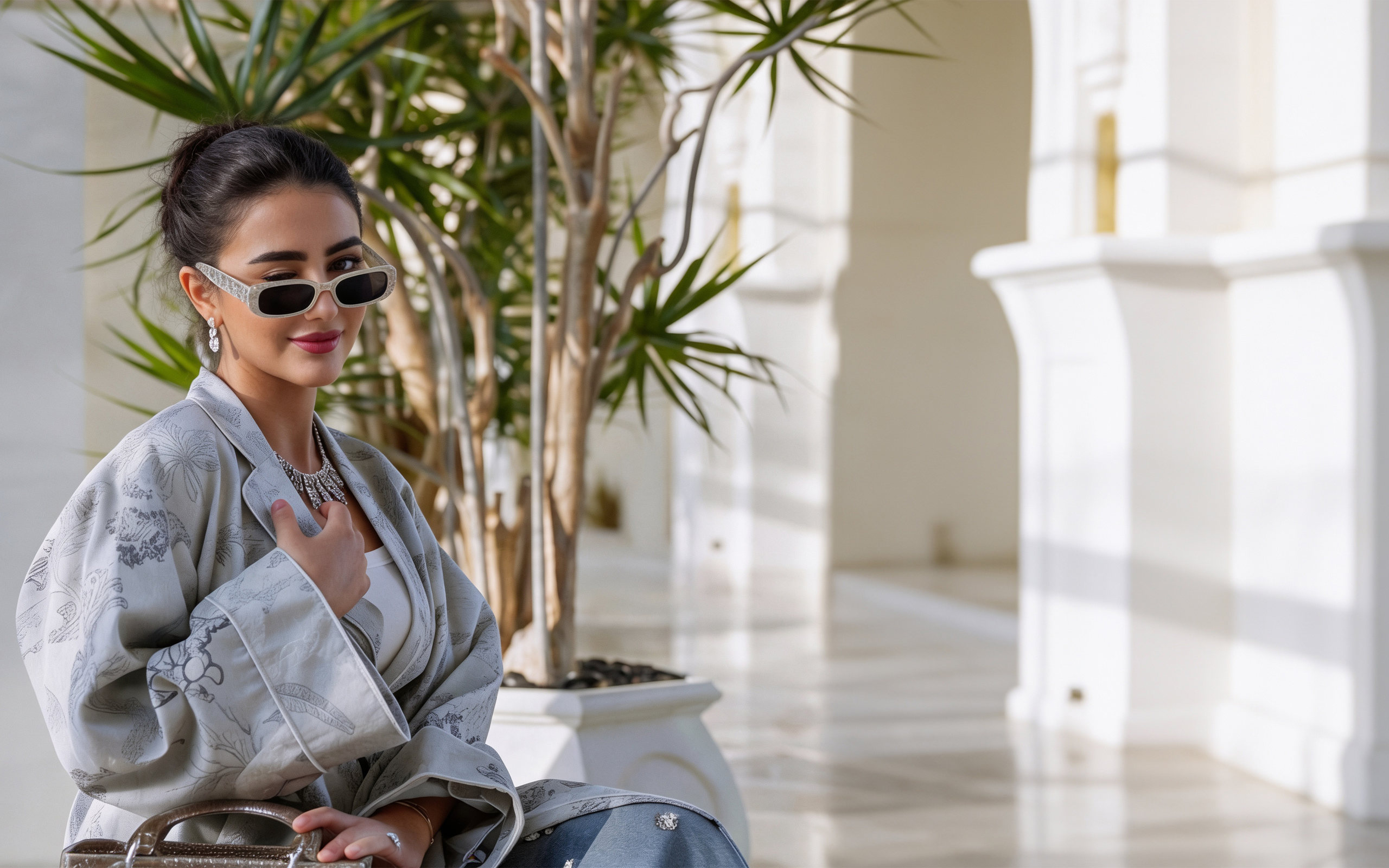 The Silver Safari silk coat in a palm courtyard — MOI SIGNORA