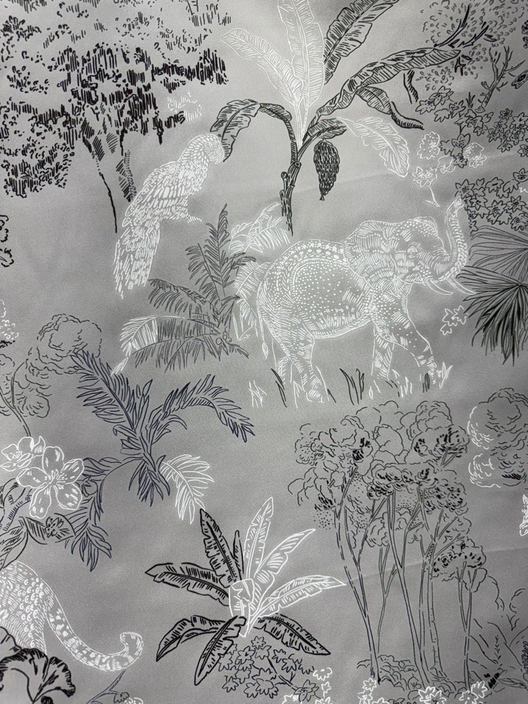 The Silver Safari silk toile in close detail — ink-drawn elephant, parrot and palms on silver silk