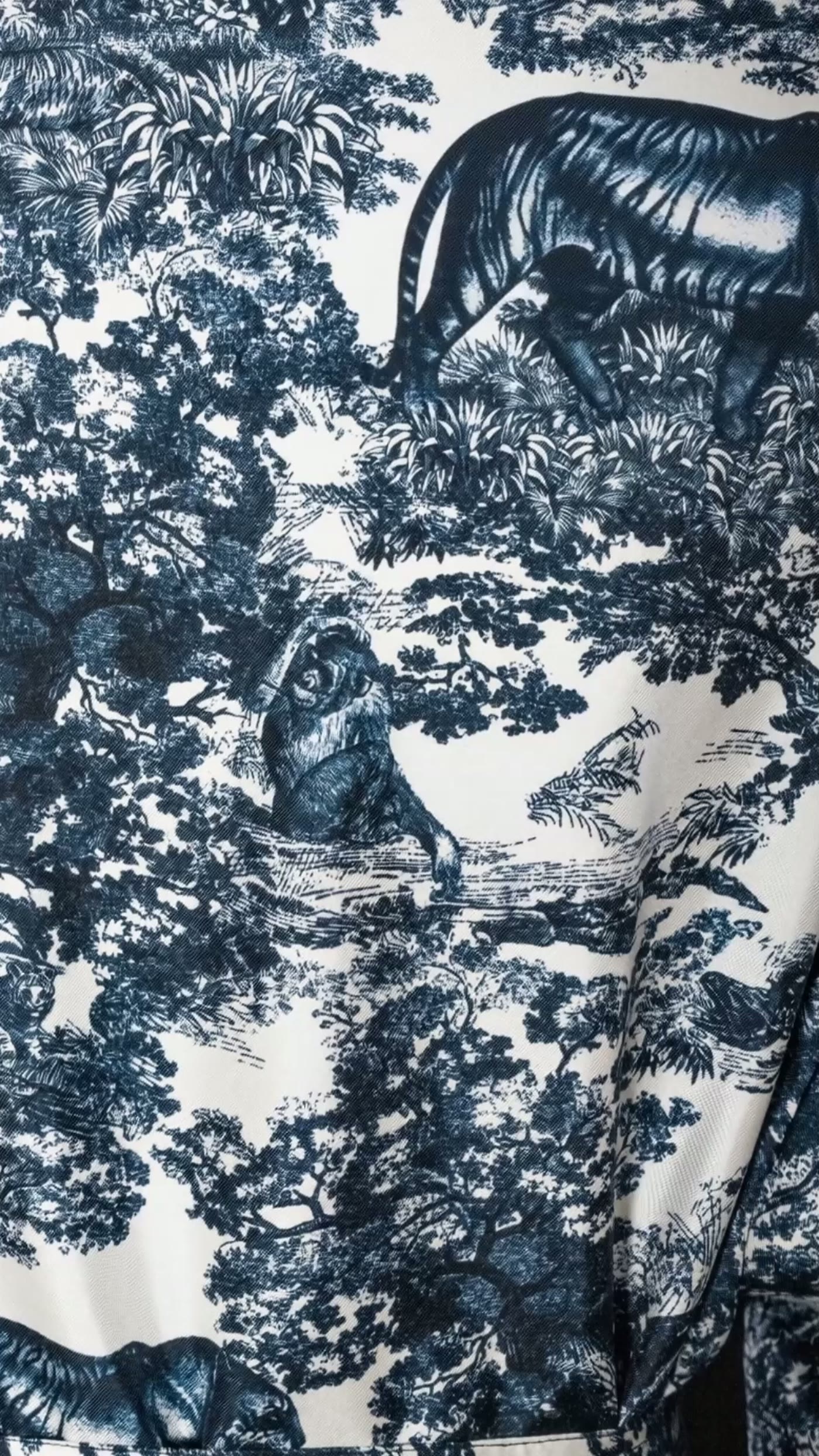Macro of the navy silk — a black tiger moving through inked forest
